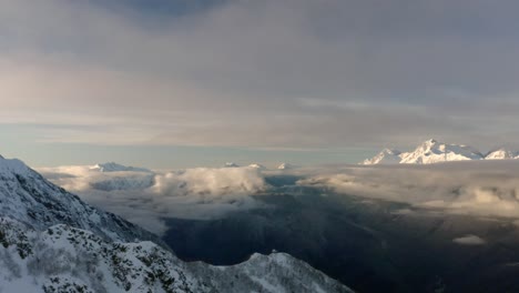 Above-the-Clouds-Aerial-View-of-Snowcapped-Mountains-in-the-Wintertime