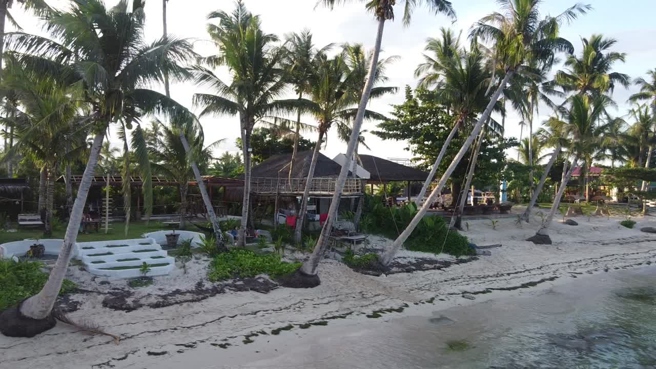 Shakabrah beachfront Caf&eacute; and homestay on tropical beach amid leaning coconut palms, Siargao