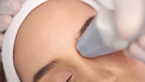 beautiful great close up and slow motion shot of a facial cleansing routine with modern machines on a very beautiful young woman with beautiful white skin complexion.