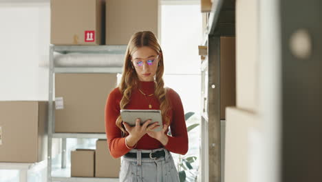 woman managing inventory with tablet in warehouse