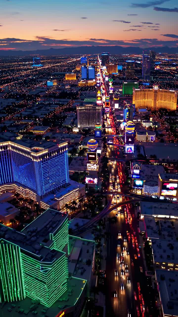 Aerial view of a vibrant cityscape at dusk, showcasing illuminated buildings and bustling streets