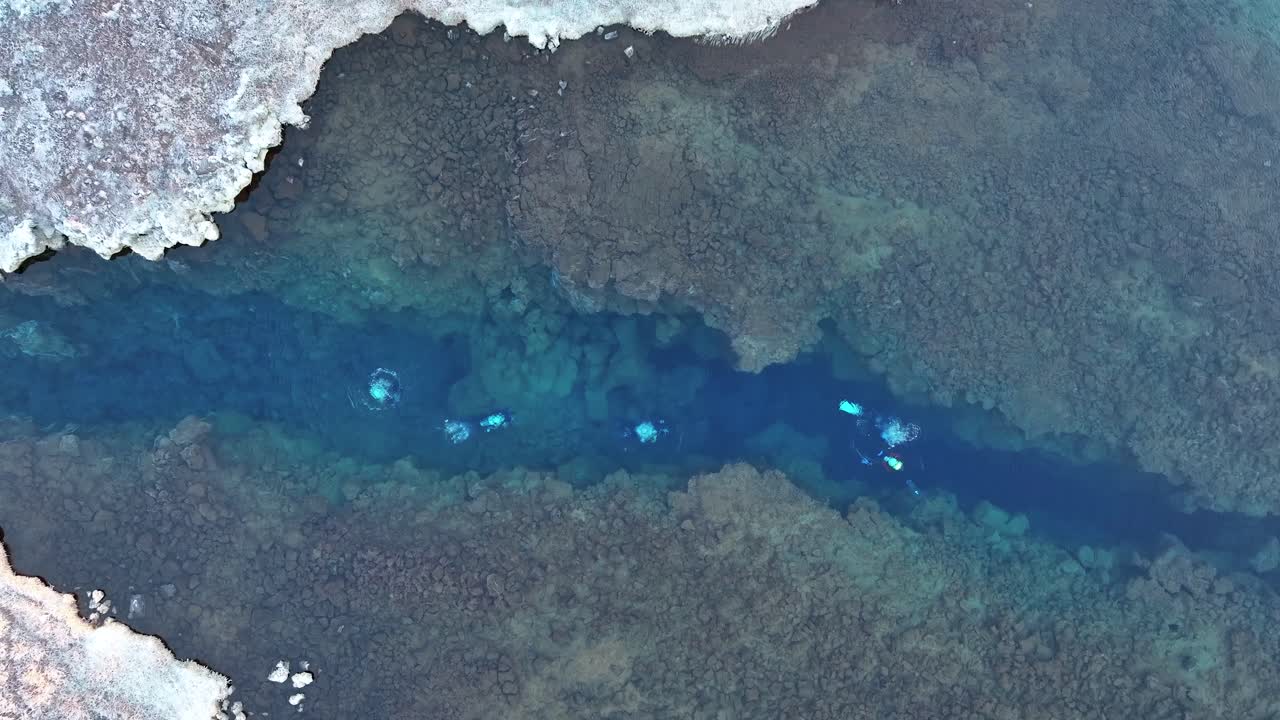 Diving Into The Crystal Blue Water Of Silfra Rift In Thingvellir National Park, South Iceland