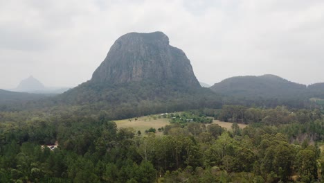 View-Of-Mount-Tibrogargan-On-A-Foggy-Day-In-The-Glass-House-Mountains-National-Park-On-Sunshine-Coast,-Queensland,-Australia---aerial-shot