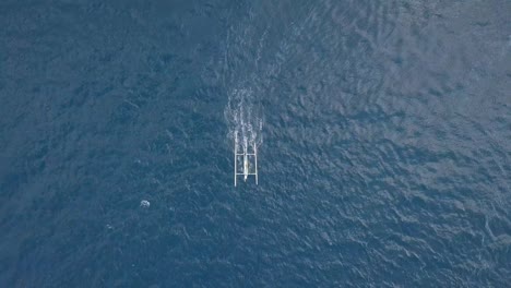 aerial view of tropical blue ocean with a small boat moving speedily