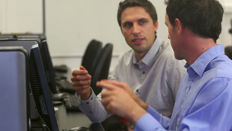 two mature students working in computer class