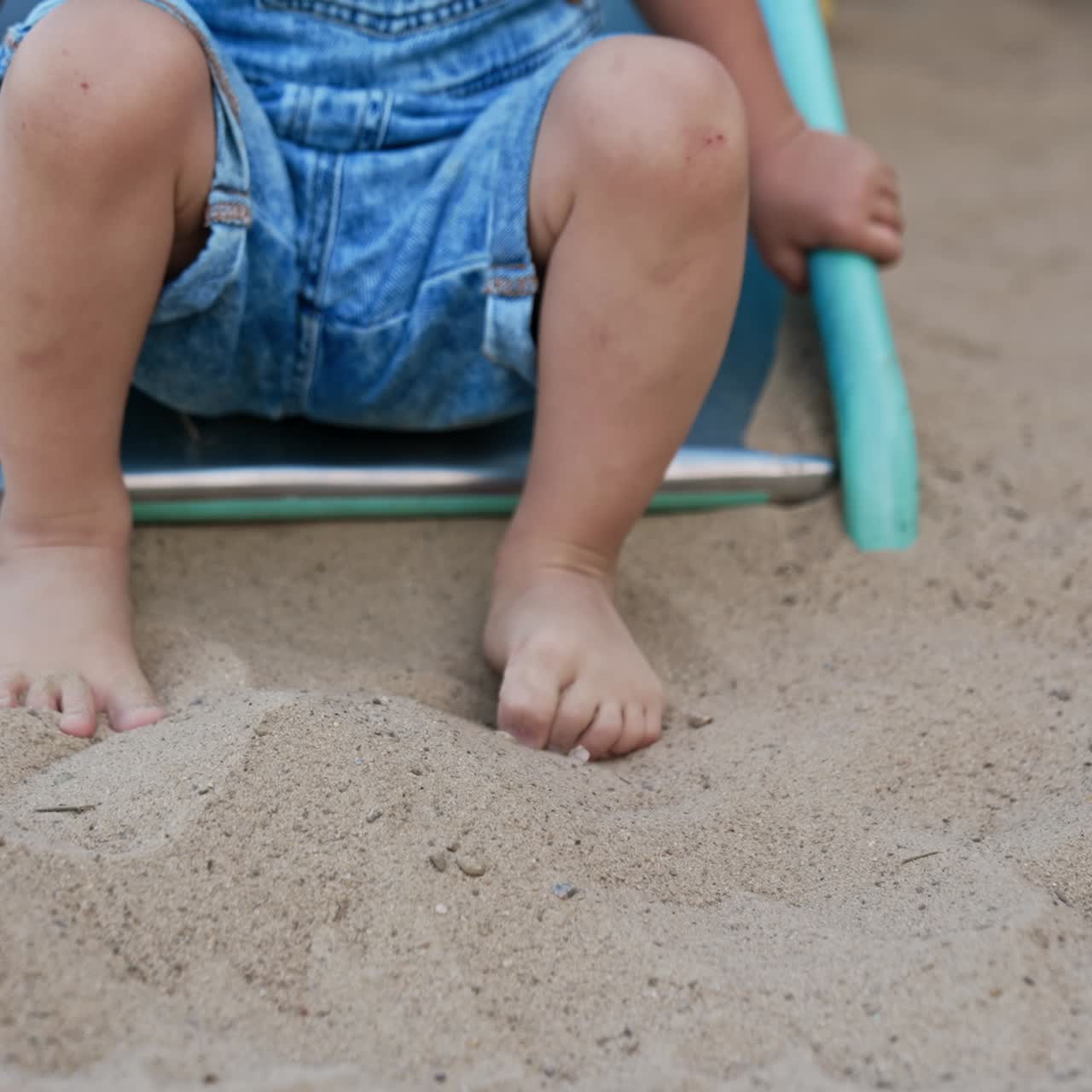 Happy little playful child in park. Small boy on colorful playground