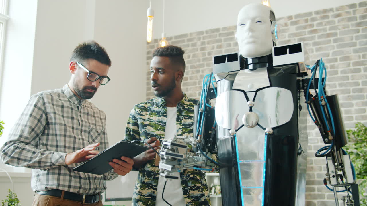 Two engineers working on a humanoid robot