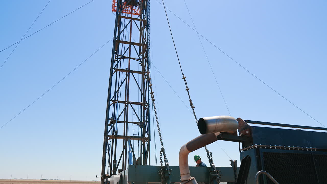 A truck with derrick for drilling natural resources. Boring site for oil production in the desert.