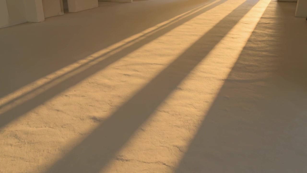Moving angled shadows sliding along pale cracked floor with sun shifting, far opening brightening