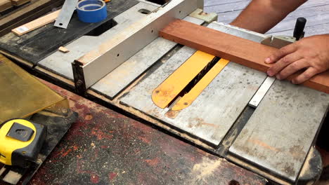 table saw cutting grooves in mahogany board