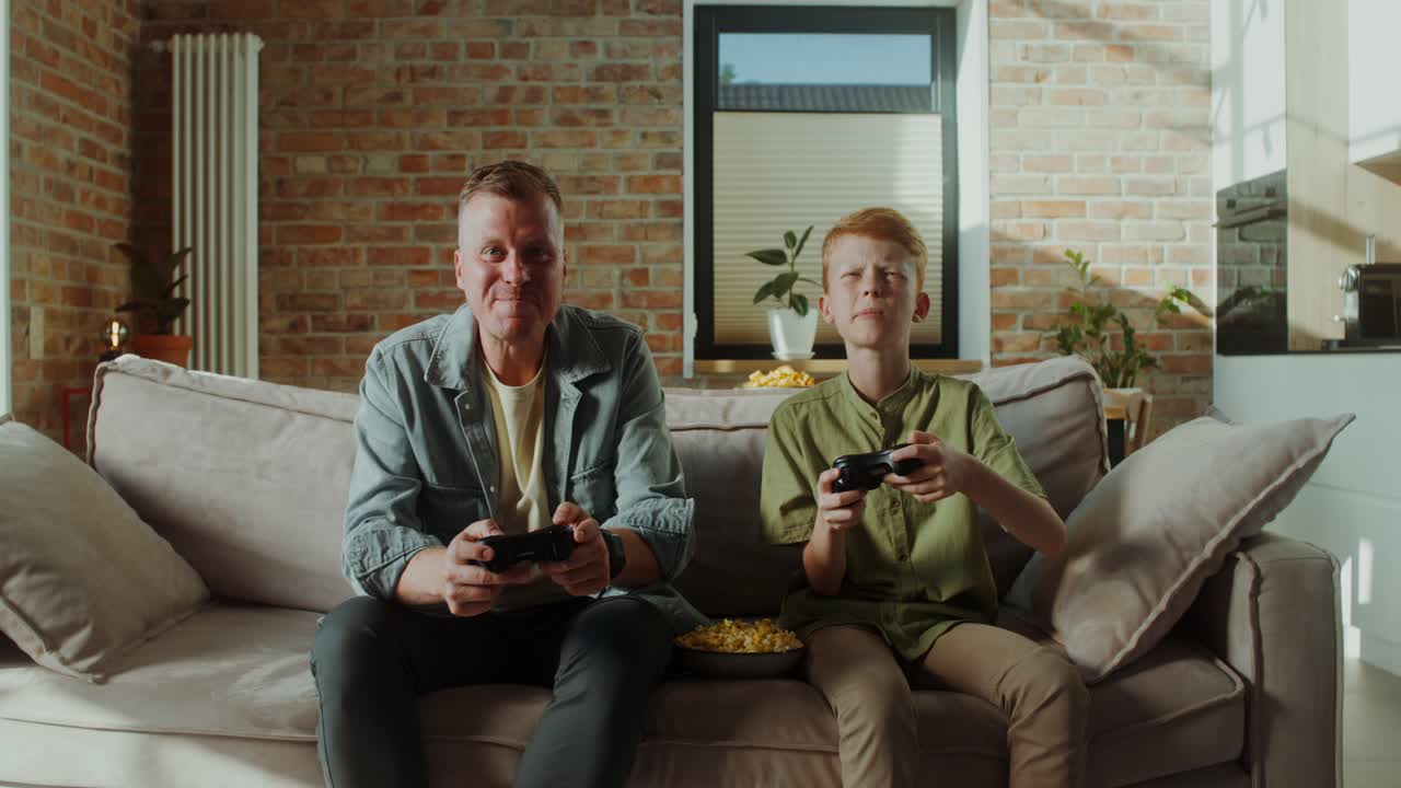 Father and Son Enjoying Video Games Together at Home
