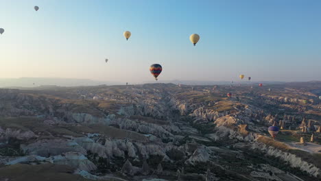 epic cinematic aerial drone shot flying among the hot air balloons over cappadocia, turkey