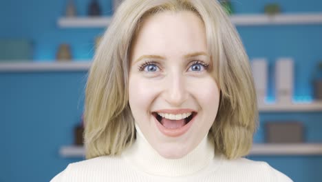 Young-woman-looking-at-camera-with-amazement-and-happiness.