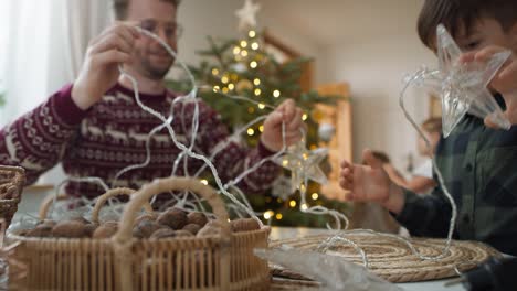 dad with son trying to untangle the cable with the light