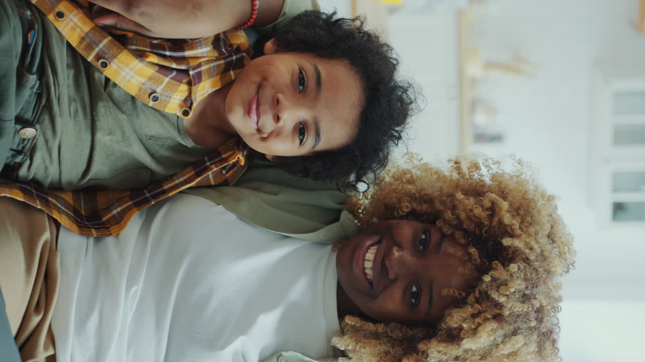 Portrait of Joyous African American Mom and Little Son Hugging on Couch at Home