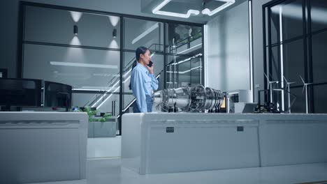 woman engineer talking on phone in modern industrial office