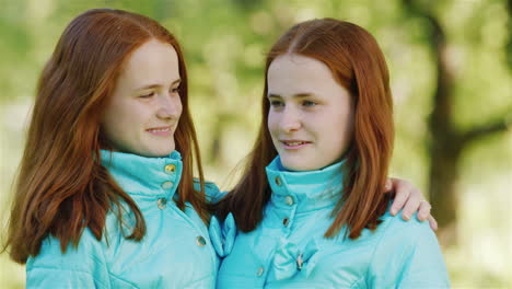 close-up portrait of two happy sisters twins 1