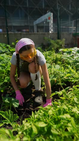 teenage girl gardening in an urban community garden