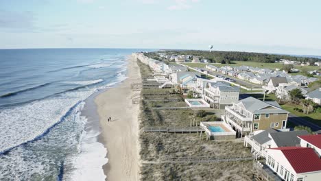 aerial drone flying over vacation homes on sunny carolina beach