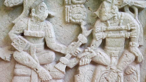 close up and tilt up movements over a craved mayan stone at copan