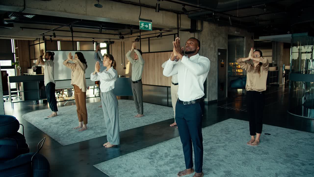The practice of calmness and meditation for business people in the office. Break at work for group meditation in an international team