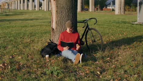 man reading in a park