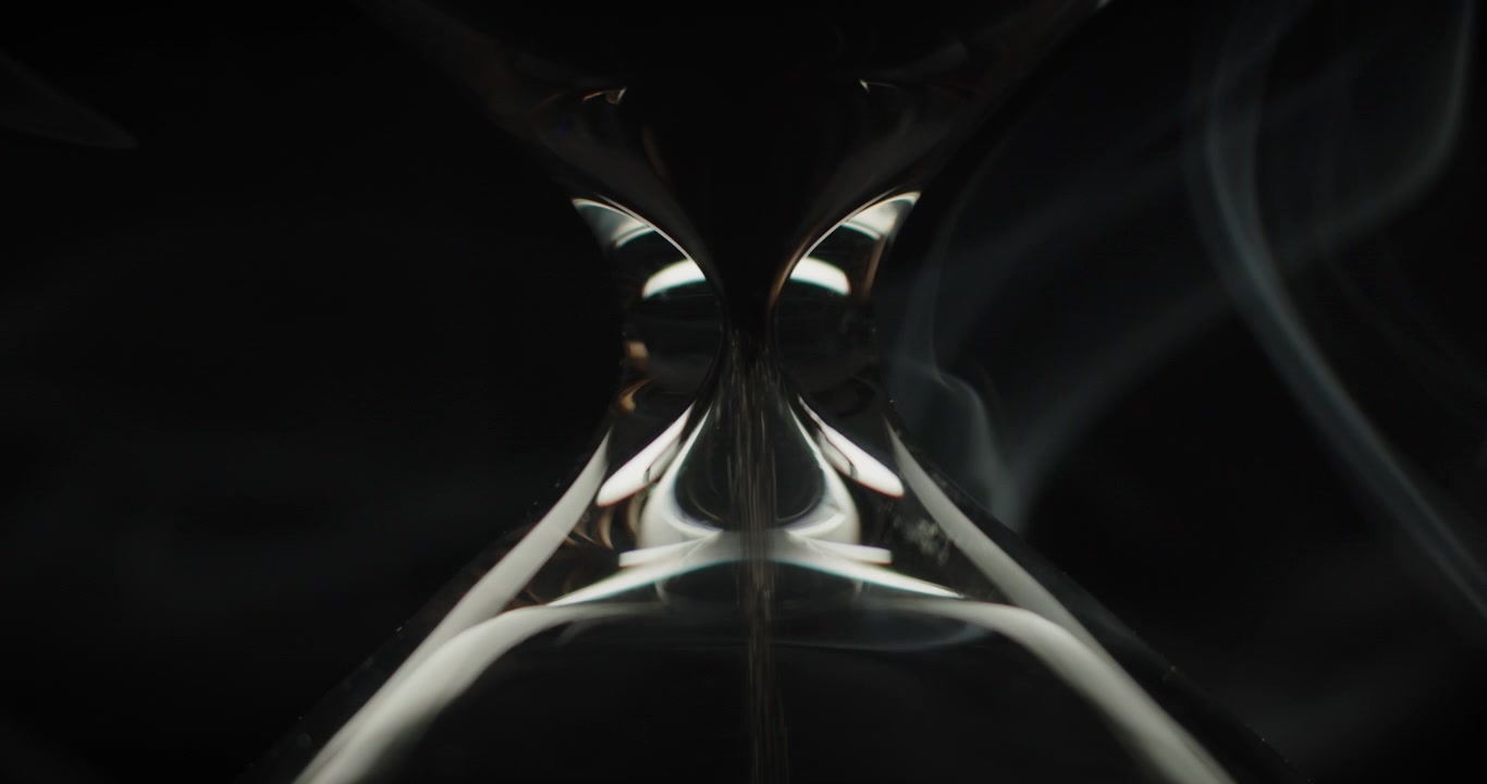 Close up of sand pouring in hourglass