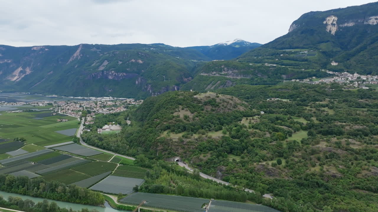 Aerial footage flying over vast fields of grapes in a valley rotating around Biotop Castelfeder in the Autonomous Province of Bolzano in Italy.