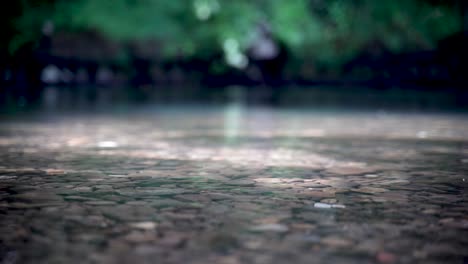 Agua-Cristalina-Del-Río-Que-Fluye-Sobre-El-Lecho-Del-Río-De-Guijarros,-Poca-Profundidad-De-Campo,-Fondo-De-Bokek