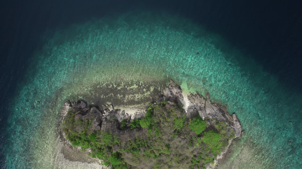 Aerial view of an island surrounded with turquoise water in Philippines.