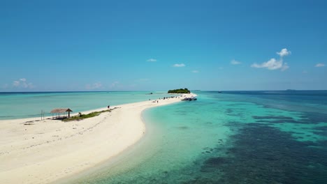 bounty-island-in-Malaysia,-low-flying-aerial,-azure-blue-sea,-sunny-white-sand-beach