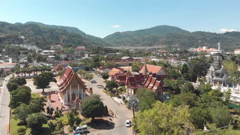 Amplia-Panorámica-De-Los-Terrenos-Del-Templo-De-Wat-Chalong-En-Un-Día-Caluroso-Y-Soleado-En-Phuket,-Tailandia---Plano-Panorámico-Aéreo-De-ángulo-Bajo