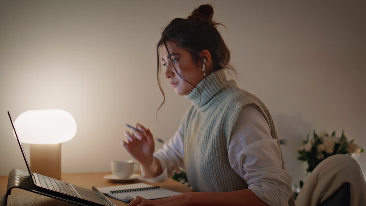 Talking woman video calling late at home closeup. Student looking smartphone