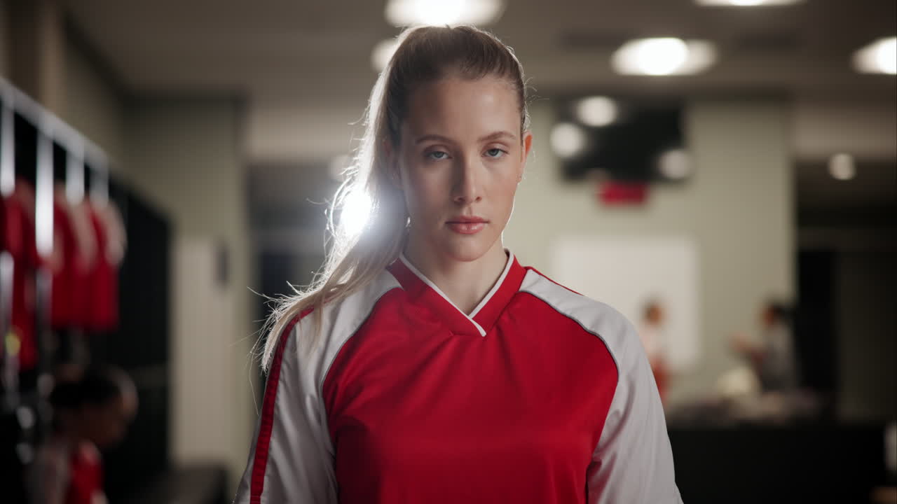 Portrait of a female soccer player in a locker room