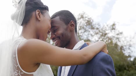 happy african american bride and groom dancing at their wedding in garden, slow motion