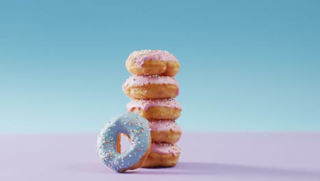 video of donuts with icing on pink and blue background