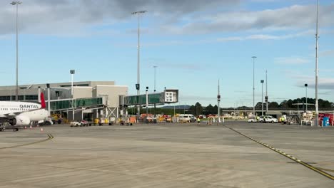 airplanes move across a sunlit airport tarmac with clear skies, showcasing a busy and organized aviation environment
