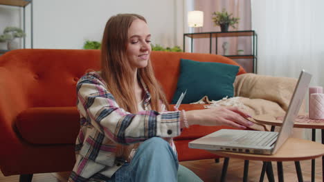 mujer joven sonriente feliz contando dinero en efectivo y el uso de computadora portátil calcular facturas domésticas en casa
