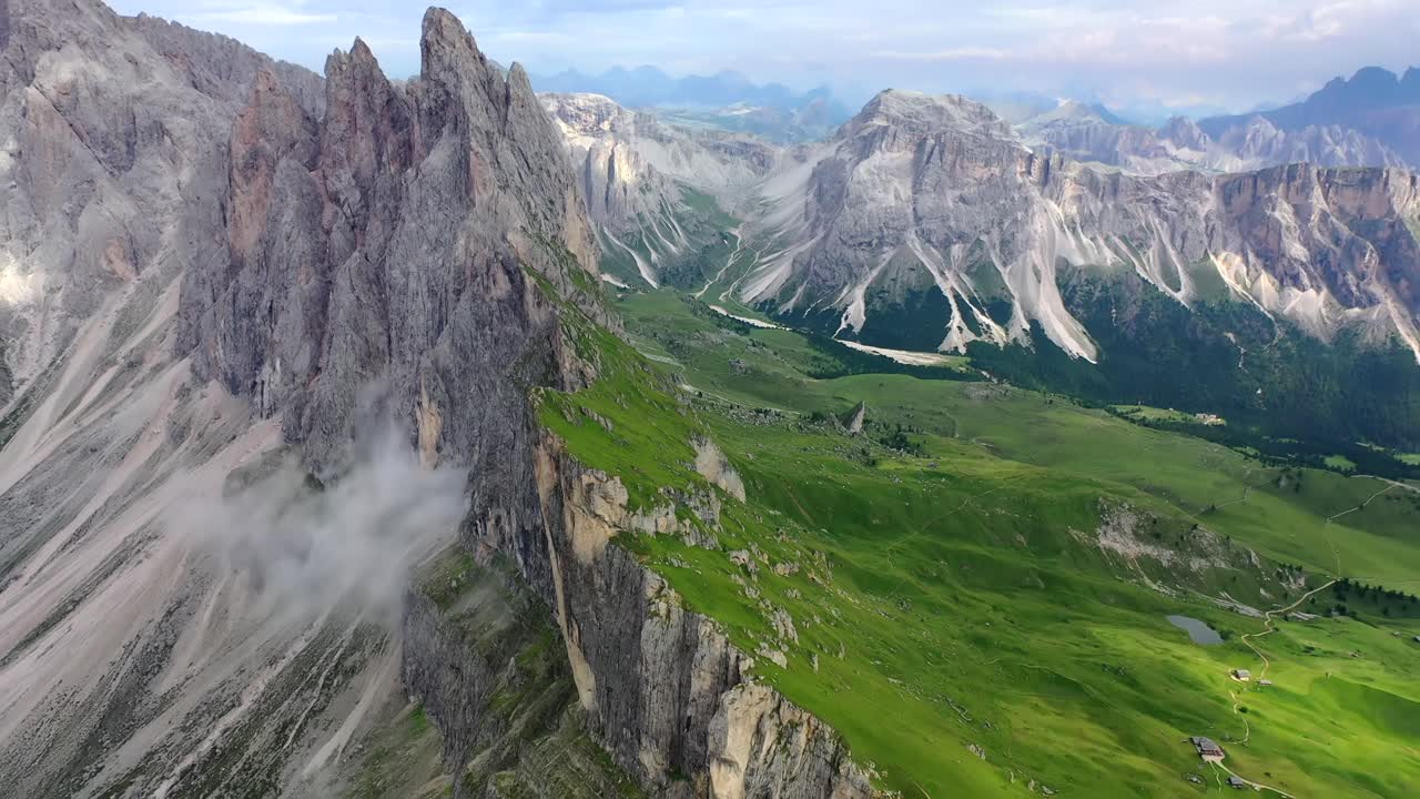 Seceda mountain and Val Gardena in summer, tilt up aerial