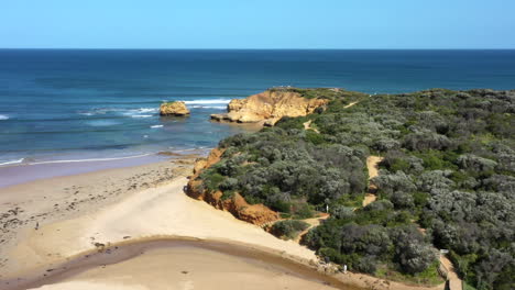 aerial over a limestone rocky point lookout on blue sky summer day