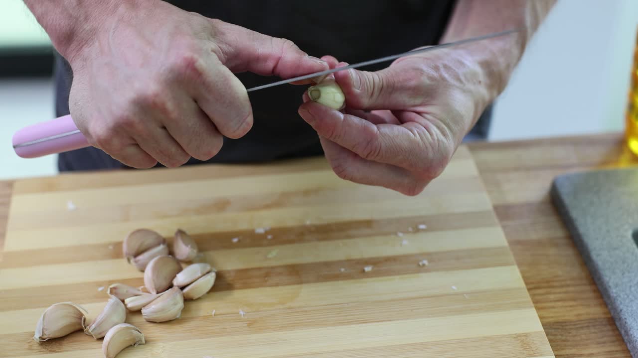 Preparing garlic on a wooden cutting board