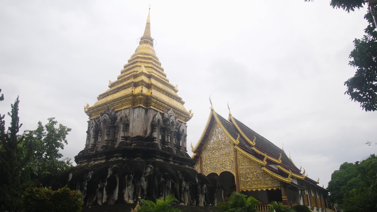 Ancient Buddhist temple with golden details in Chiang Mai, Thailand, peaceful setting