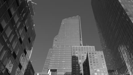 driving past residential buildings in neighborhood of manhattan in busy new york downtown business district with high glassy skyscrapers and big contemporary office buildings