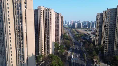 aerial: taicang residential area with high-rise apartments and cityscape during the day in jiangsu province, china, establishing drone shot