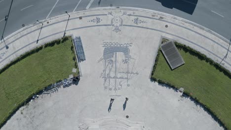 close-up of the shadow of two tourists reflected on the historic sidewalk and cobblestone in lisbon