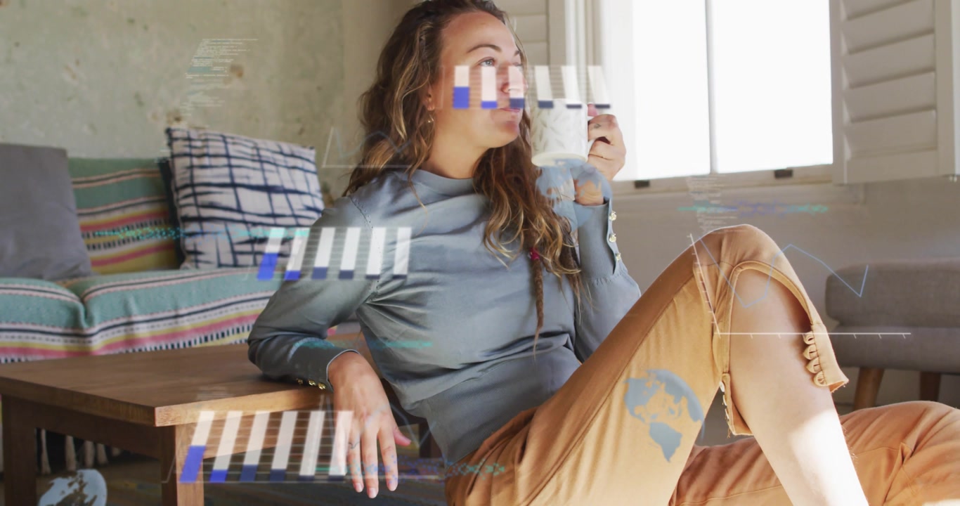 woman lifting mug sipping causing animated bar chart globe icon and line graph during tech analysis