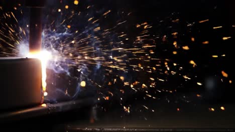 dynamic sparks erupting from intense welding process, showcasing brilliant flames and explosive energy of metal fabrication techniques in action
