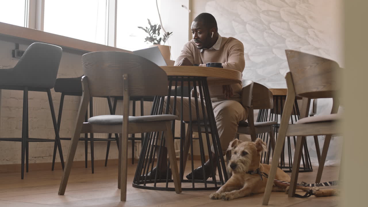 Afro American Businessman with Dog in Cafe