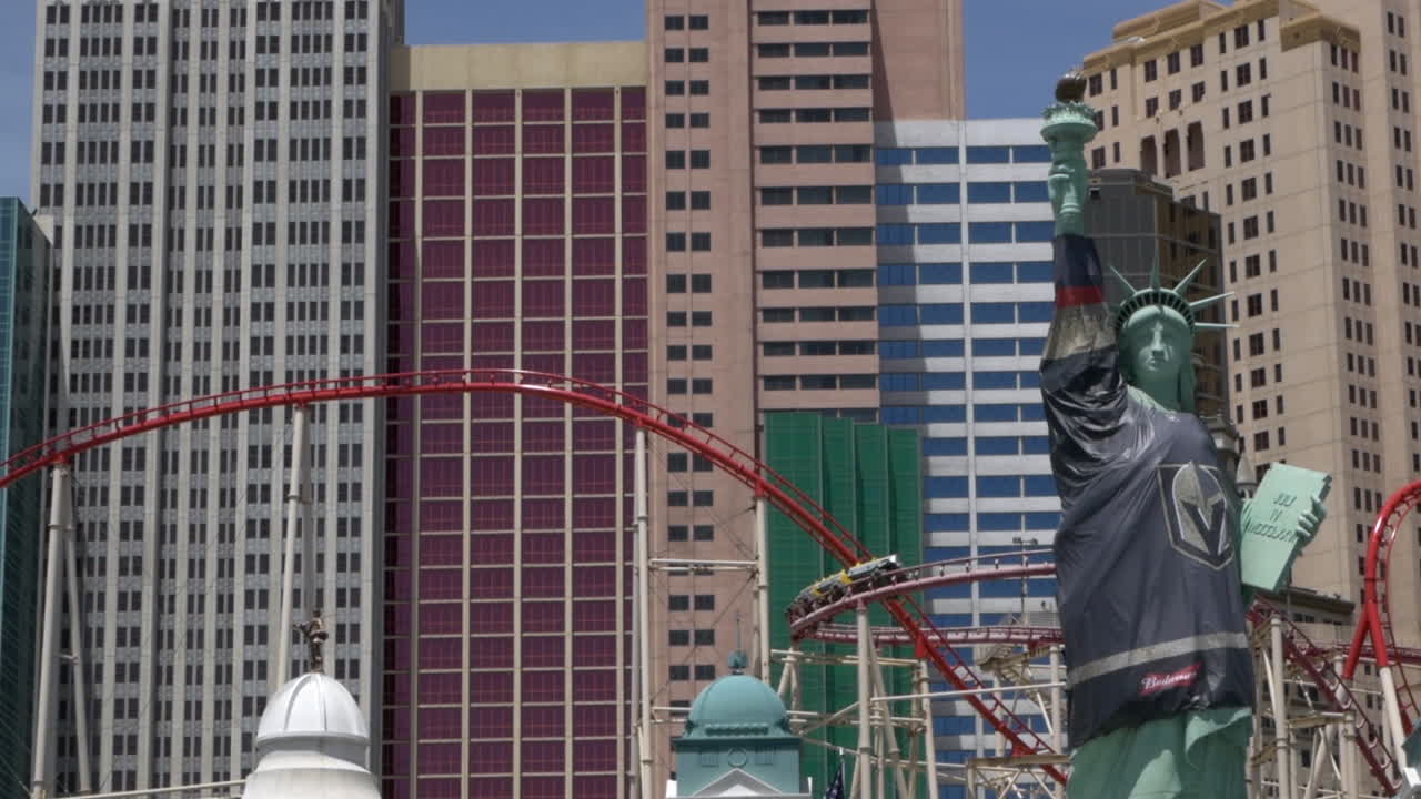 The roller coaster at New York-New York Hotel - Casino rounding a curve and taking a plunge
