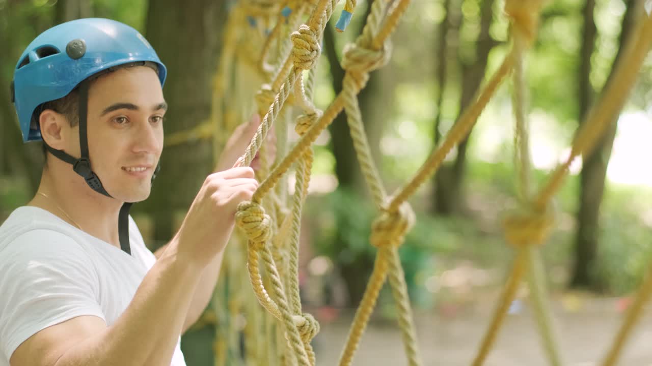 aventura de escalada parque de alambre alto - hombre en curso en casco de montaña y equipo de seguridad